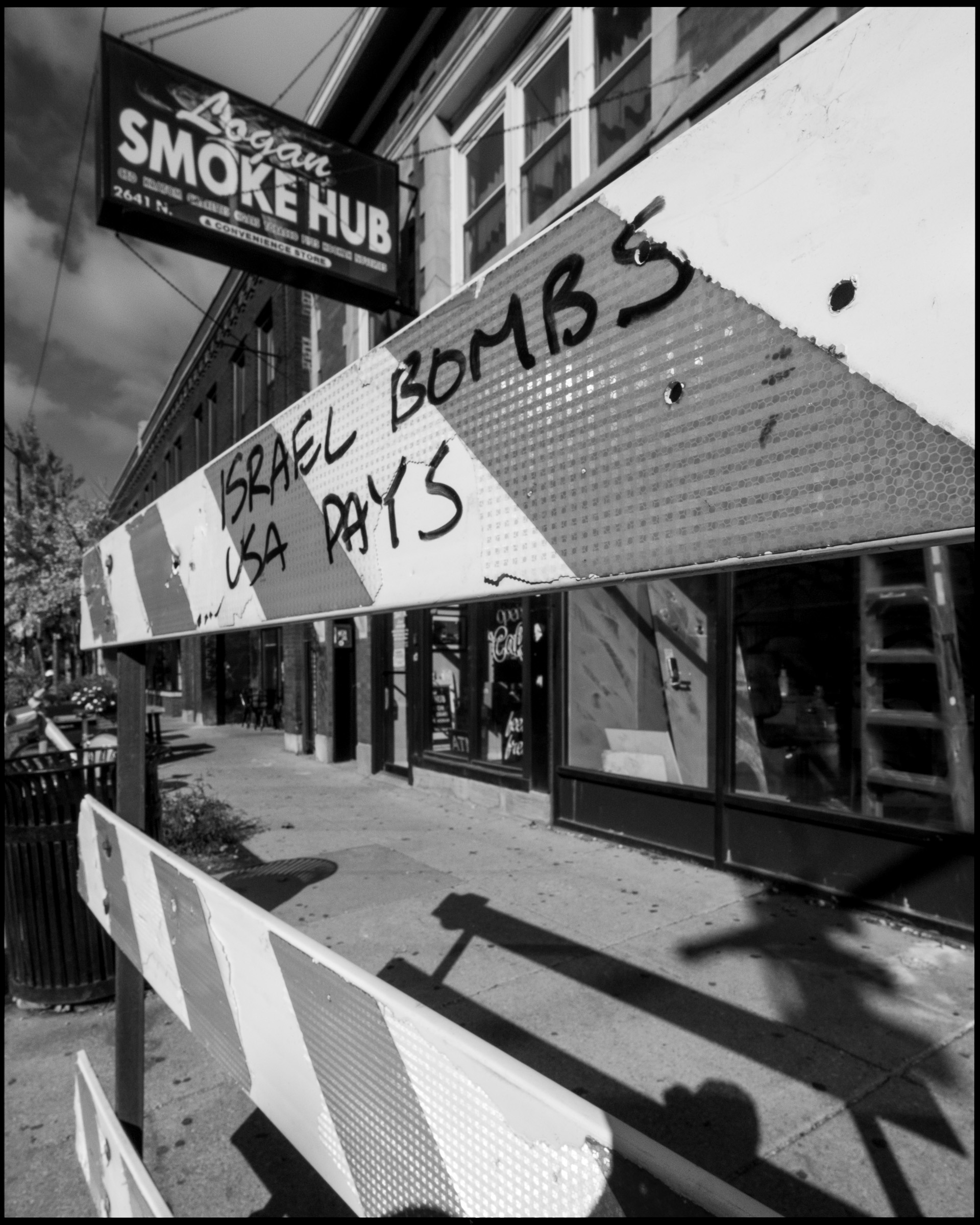 Graffiti reading Israel Bombs USA Pays, Logan Square Chicago 2024